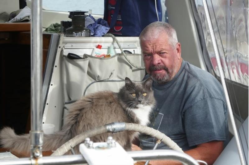 Mike enjoys a cup of coffee in the cockpit of Tamure ll, attended by his faithful cat photo copyright Lisa Benckhuysen taken at 