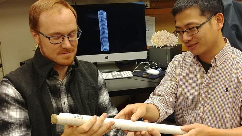 MIT-WHOI Joint Program student Nathaniel Mollica (left) and WHOI scientist Weifu Guo examine a core extracted from a coral skeleton. - photo © Anne Cohen Lab, ©Woods Hole Oceanographic Institution