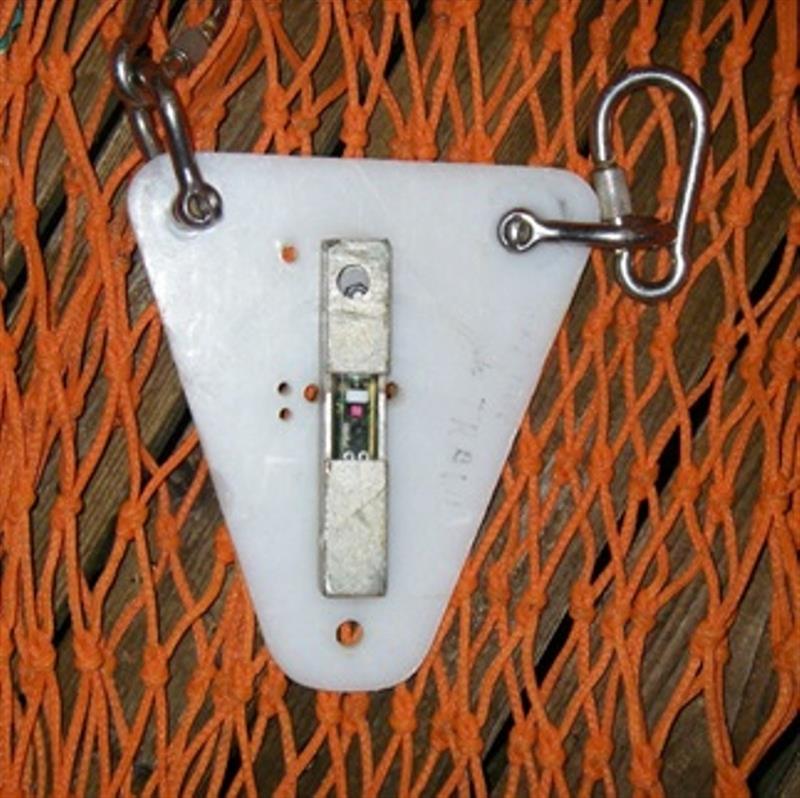 Light sensing archival tag attached to bottom trawl net. - photo © NOAA Fisheries