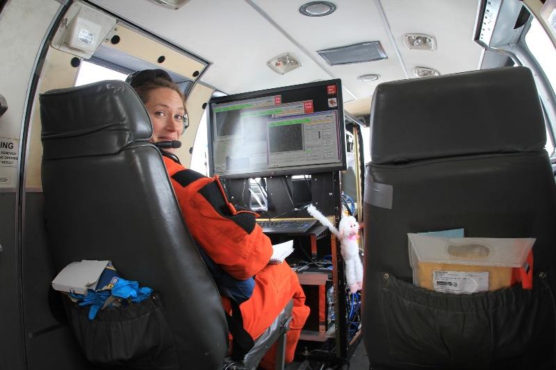 Cynthia Christman (NOAA Fisheries Affiliate/University of Washington) monitors cameras for polar bears and seals while flying over Chukchi Sea ice. - photo © NOAA Fisheries