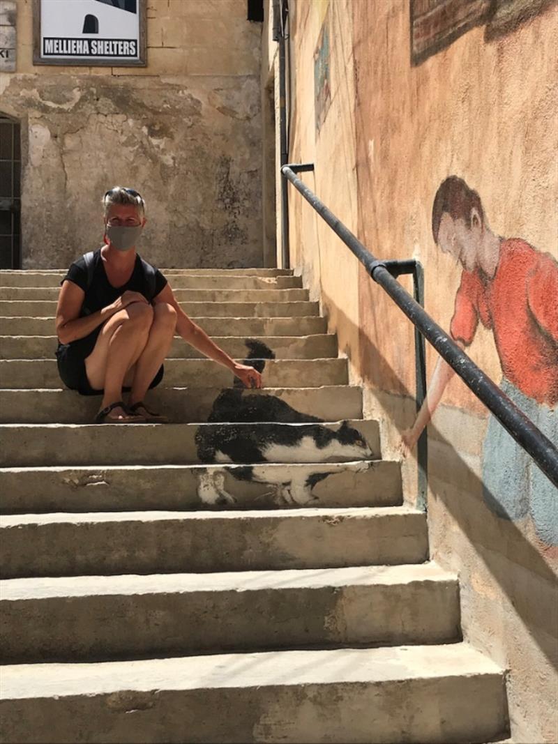 Yolene with some funky street art in Mellieha Bay - photo © SV Red Roo