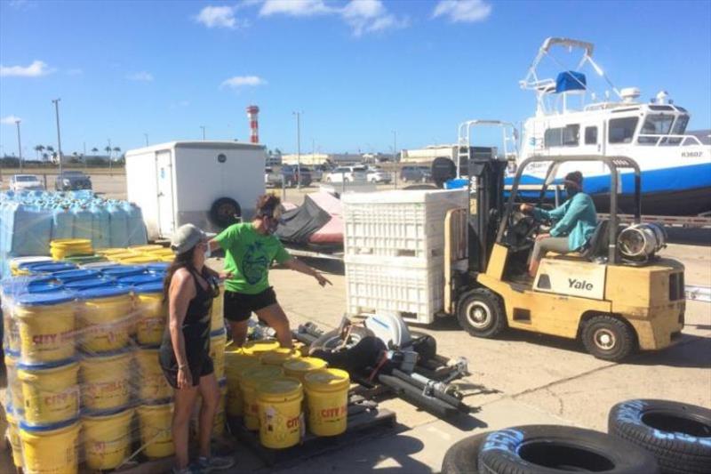 Teams worked in groups, wore masks, and took precautions to protect personnel from Covid-19. Research expeditions to the remote Papahanaumokuakea take a lot of gear - these buckets are color coded for biosecurity system that keeps each island safe photo copyright NOAA Fisheries taken at 