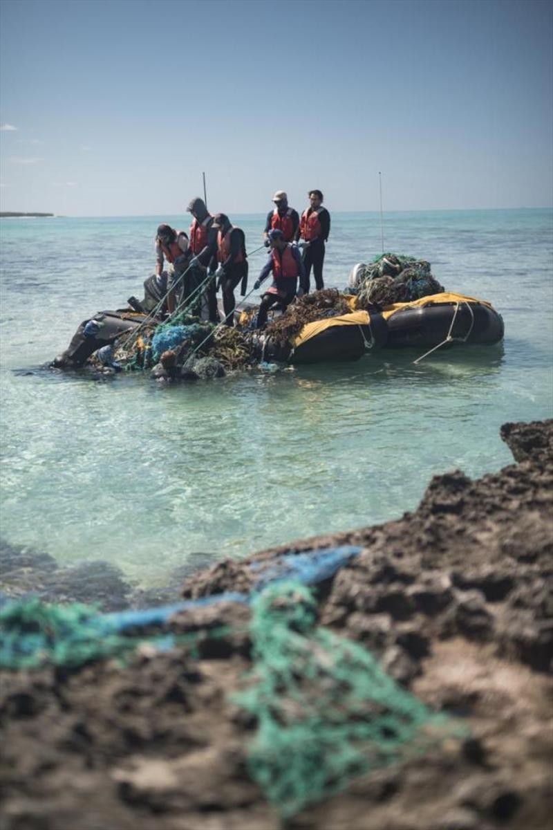 NOAA's marine debris team works together to remove a large derelict fishing net from Midway Atoll in 2018 photo copyright NOAA Fisheries / Steven Gnam taken at 