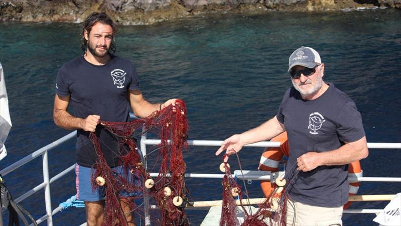 Stefano Marsala, a volunteer with Sea Shepherd, Italy, pulls up an illegal fishing net with WHOI scientist Alex Bocconcelli in the Aeolian Islands photo copyright Nicole El Haddad / Woods Hole Oceanographic Institution taken at 