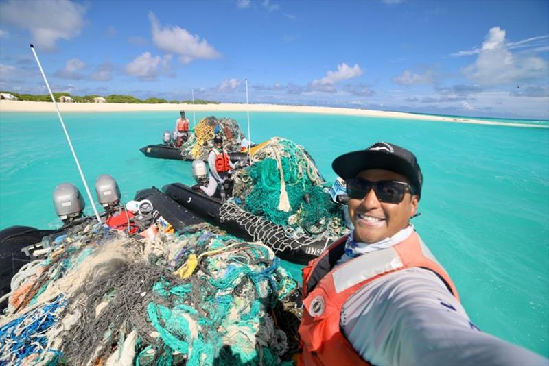 NOAA Coxswains James Morioka, Rebecca Weible, and Andrew Gray pose with their boats full of derelict fishing nets removed from Kapou (Lisianski Island) photo copyright NOAA Fisheries / James Morioka taken at 