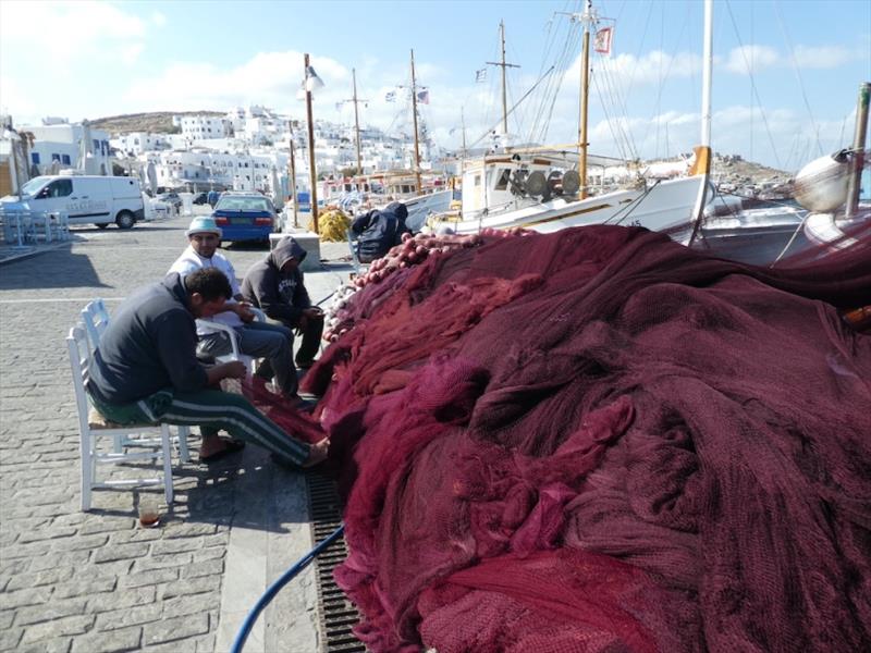 Mending the nets, fishing boats didn't leave the harbour for 10 days either photo copyright SV Red Roo taken at 