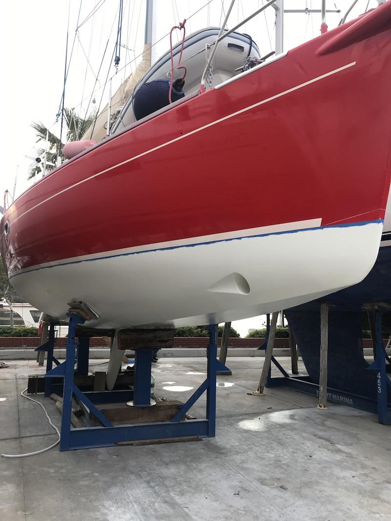 First coat of antifoul on bottom (blue masking tape to be removed after second coat) - photo © SV Red Roo