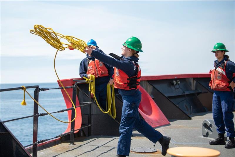 Seaman Penelope Buel, a crewmember aboard the Coast Guard Cutter Healy, throws a heaving line during training the Pacific Ocean, July 13, 2023 - photo © Petty Officer 3rd Class Briana Carter