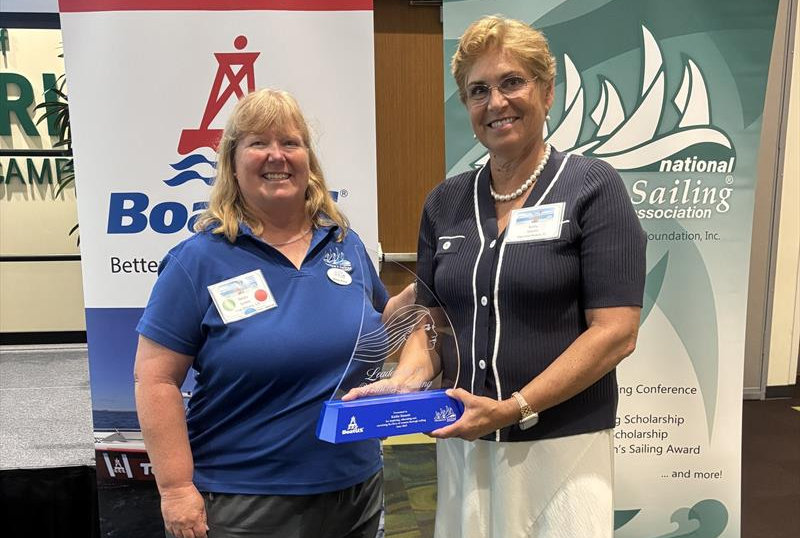 (R to L) Kathy Sinnett accepting 2025 BoatUS/NWSA Leadership in Women's Sailing Award from Debby Grimm, President, National Women's Sailing Association - photo © Jan Pehrson