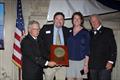 Christopher and Molly Barnes, center, receive the 2025 Far Horizons Award. With them are incoming CCA Commodore Chace Anderson, left, and outgoing CCA Commodore Jay Gowell &copy; Guy Gurney