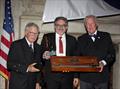 Philip “Greg” Velez, center, receives the Rod Stephens Seamanship Trophy from the incoming CCA Commodore Chace Anderson, left, and outgoing CCA Commodore Jay Gowell &copy; Guy Gurney