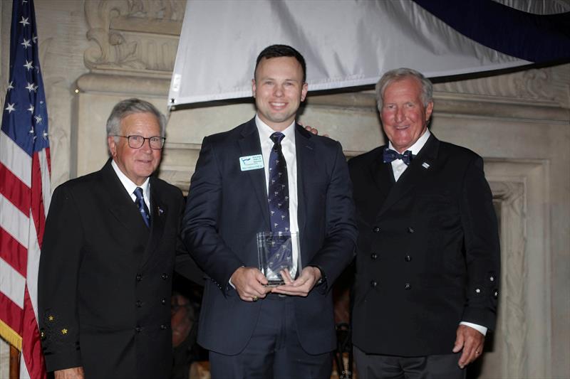 Peter Gibbons-Neff Jr., receives the 2025 Charles H. Vilas Literary Prize, with the incoming CCA Commodore Chace Anderson, left, and outgoing CCA Commodore Jay Gowell - photo © Guy Gurney