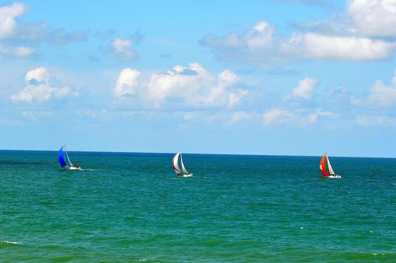 Gulfstreamer competitors pass the Daytona Beach Main Street Pier en route to the finishing line off of Charleston, South Carolina photo copyright GulfStreamer Offshore Sailboat Challenge taken at Halifax River Yacht Club and featuring the PHRF class