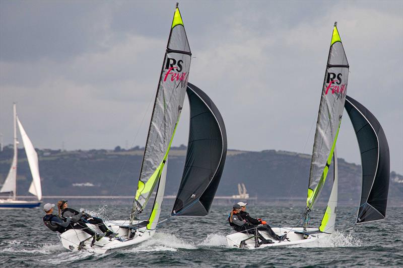 Millie Greenhalgh and Tom Sinfield trying to roll Phoebe and Ben Greenhalgh - RS Feva Grand Prix at Ballyholme photo copyright Simon McIlwaine / www.wavelengthimage.com taken at Ballyholme Yacht Club and featuring the RS Feva class