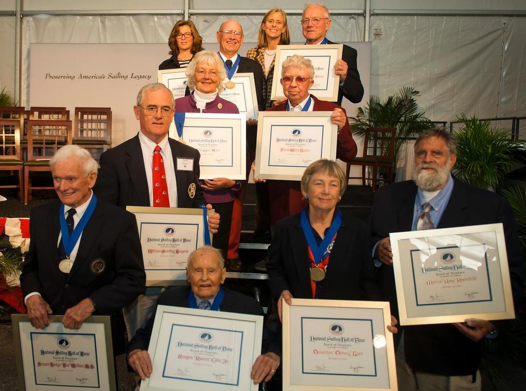 NSHOF Inductees (from bottom, left to right):<br />
Stuart Walker, Runnie Colie, Timmy Larr,Richard Rosenfeld (accepting for grandfather Morris Rosenfeld) Steve Taylor (accepting for grandfather Starling Burgess) Julia Clough (accepting for grandfather John Alden), Frank Butler Brooke Blackaller*, Dave Curtis, Lisa Blackaller*, Bill Buchan (*accepting for their father Tom Blackaller) © NSHOF/Jack Hardway