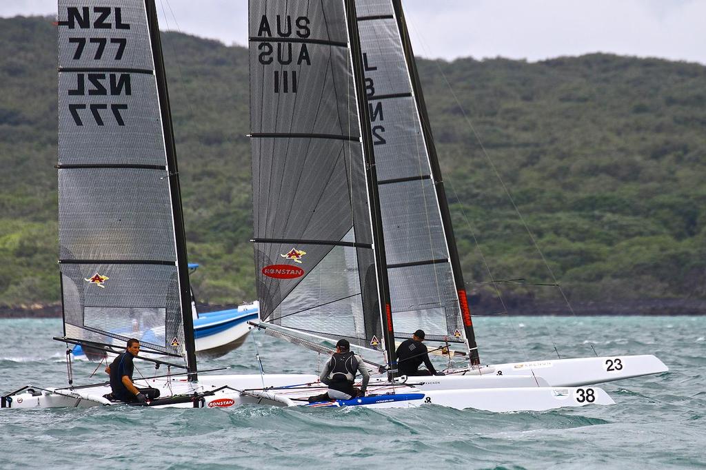 Some of the Emirates Team NZ sailors gather for a chat between races A-class catamaran World Championships, Day 3, Takapuna February 13, 2014 © Richard Gladwell www.photosport.co.nz