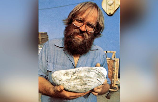 Jack Corliss, a geologist at the University of Oregon in 1977, holds a giant clam sampled from hydrothermal vents sites. The expedition was searching for hydrothermal vents and found them, but also unexpectedly found chemosynthetic life around the vents.  © Emory Kristof