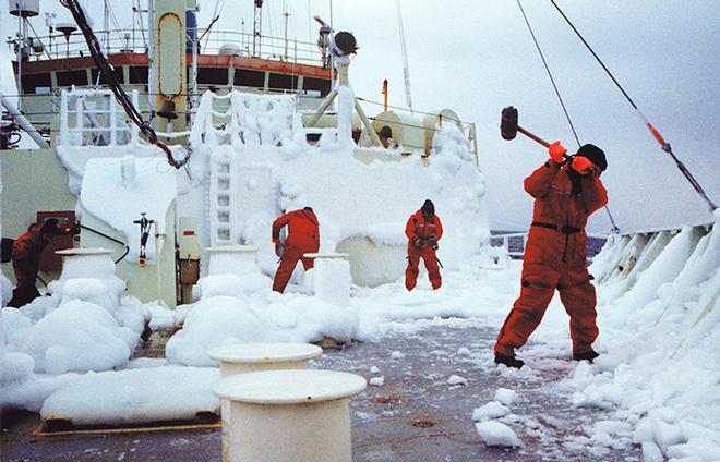 Knorr crew affectionately called themselves Knorrons. Many stayed aboard for decades, becoming a tight-knit group. They worked closely with scientists, and had a knack for overcoming challenges. On a Labrador Sea cruise in the winter of 1997, all hands had to break dangerous ice buildup from the bow, including then-Captain A.D. Colburn, swinging a mallet.  © George Tupper, WHOI