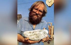 Jack Corliss, a geologist at the University of Oregon in 1977, holds a giant clam sampled from hydrothermal vents sites. The expedition was searching for hydrothermal vents and found them, but also unexpectedly found chemosynthetic life around the vents. photo copyright Emory Kristof taken at  and featuring the  class