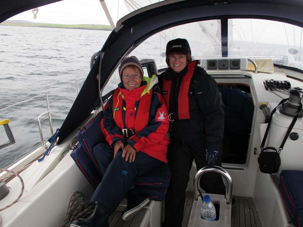 Sheryl and Shetland cruising friend, Liz Green, of SV Dream Weaver, sport summer weather outfits in June. Foul weather gear is needed for sailing just about everyday of the year. © Paul and Sheryl Shard http://www.distantshores.ca/