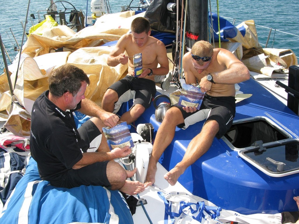 Team Delta Lloyd taking shelter in Salomique Bay, Philippines. The Crew is working hard to repair the ripped mainsail on deck. Tine for lunch on deck, (l-r) Stu Wilson, Morgan White, Gerd-Jan Poortman photo copyright Sander Pluijm/Team Delta Lloyd/ Volvo Ocean Race http://www.volvooceanrace.org taken at  and featuring the  class