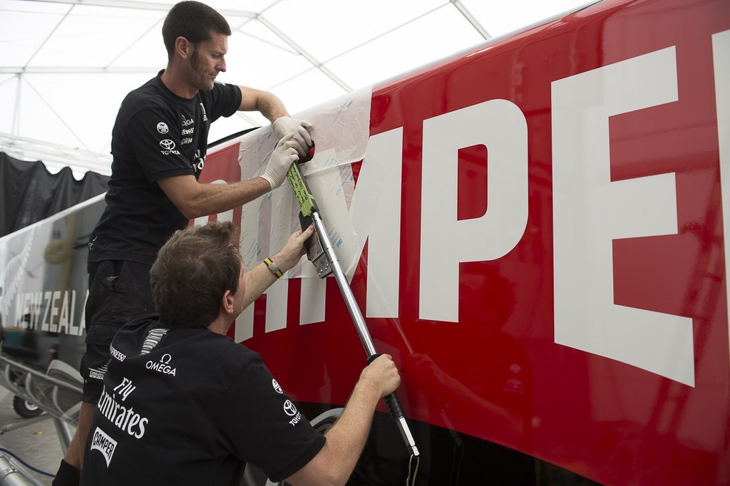 Emirates Team New Zealand shore crewmen Campbell Dickie and Dave French torque up bolts attaching the forward beam to the starboard hull of the teams second AC72. 15/1/2013 © Chris Cameron/ETNZ http://www.chriscameron.co.nz