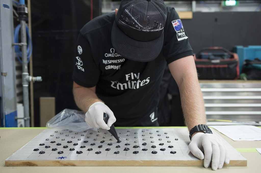 Emirates Team New Zealand’ boat builder Dan Brooks preparing mounting fixtures for AC72 number two. 16/1/2013 © Chris Cameron/ETNZ http://www.chriscameron.co.nz