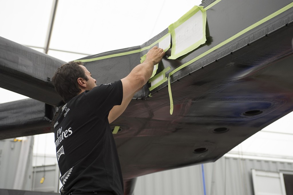Emirates Team New Zealand hydraulics engineer Vito Vattuone lays out parts drawing to check positioning of systems on the teams second AC72. 17/1/2013 © Chris Cameron/ETNZ http://www.chriscameron.co.nz