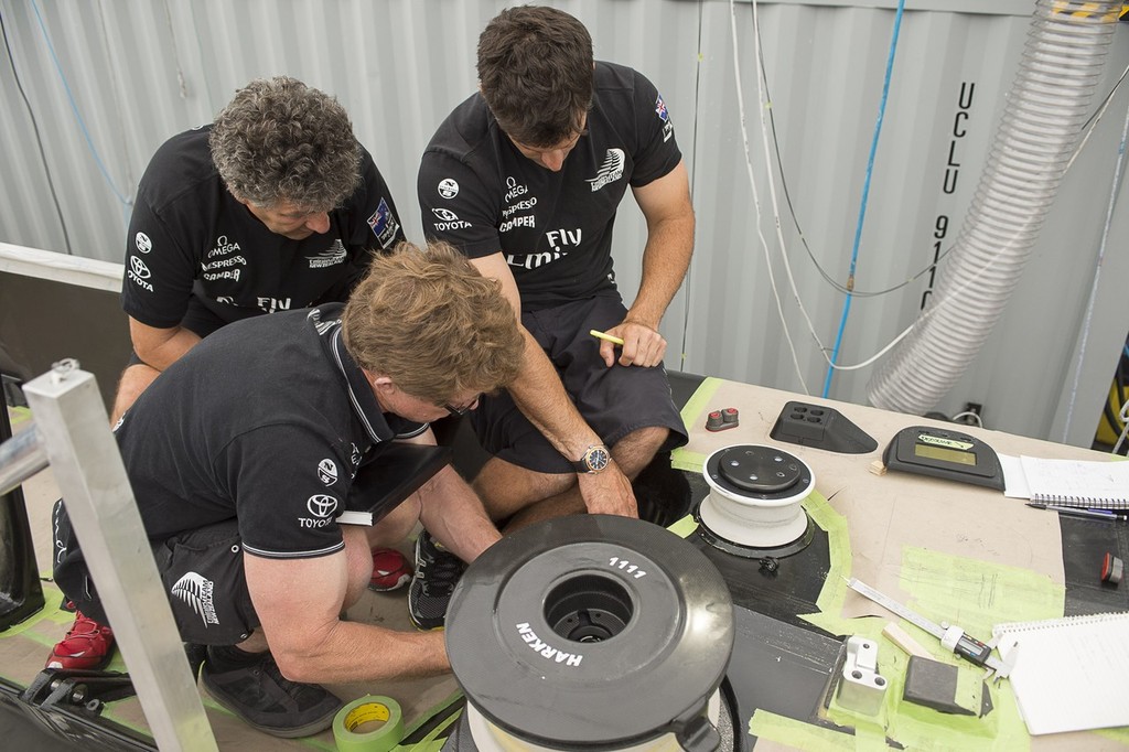 Sean Regan, Giovanni Belgrano and Jeremy Lomas discuss layout in the cockpit of Emirates Team New Zealands second AC72. 18/1/2013 © Chris Cameron/ETNZ http://www.chriscameron.co.nz