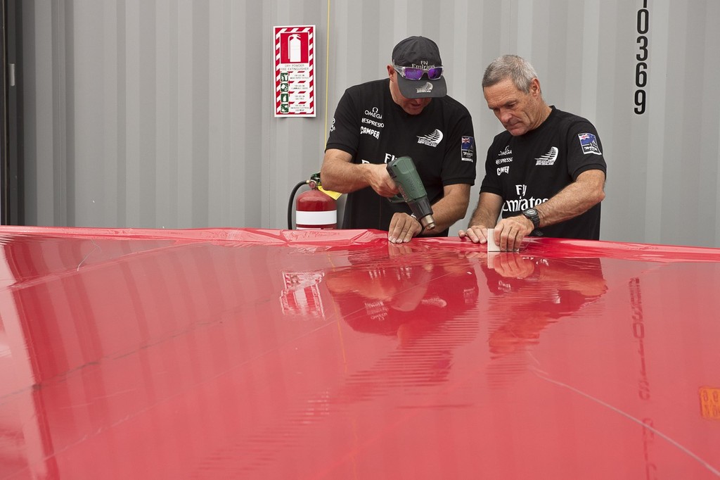 Emirates Team New Zealand, Chris Salthouse and Joe Allen stretch the Mizar skin on to one of the flaps of Wing one. 23/1/2013 © Chris Cameron/ETNZ http://www.chriscameron.co.nz