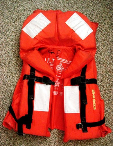 Carry at least standard Type I pfd’s (or better) aboard. Type I pfd's are easy to put on in the water, and ideal to use with the H.E.L.P. position. © Captain John Jamieson http://www.skippertips.com