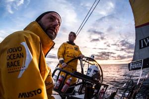 Leg 7 to Lisbon onboard Abu Dhabi Ocean Racing. Day 3. A backlit Ian Walker eyes the sail trim as Luke ``Parko`` Parkinson drives at sunset over the Atlantic Ocean. - Volvo Ocean Race 2015 photo copyright Matt Knighton/Abu Dhabi Ocean Racing taken at  and featuring the  class
