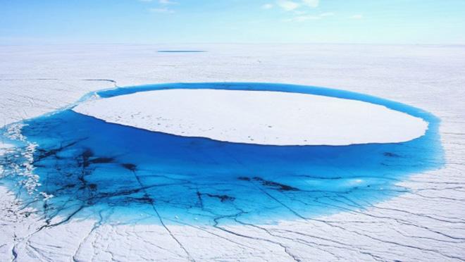 Water lies on part of the glacial ice sheet that covers about 80 per cent of Greenland © Getty Images