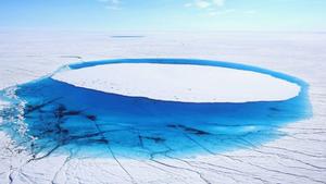 Water lies on part of the glacial ice sheet that covers about 80 per cent of Greenland photo copyright Getty Images taken at  and featuring the  class