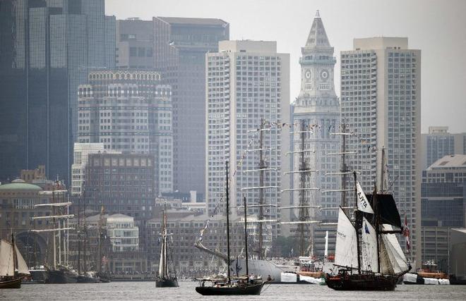 Tall ships pass in front of the skyline during Sail Boston's Parade of Sail on Saturday ©  Michael Dwyer / AP