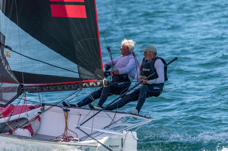 Murray Press and Mark Muirhead stretch on Red Energy - 2026 triSearch 12ft Skiff Interdominion Championship on Sydney Harbour Day 2 - photo © @sprottmedia