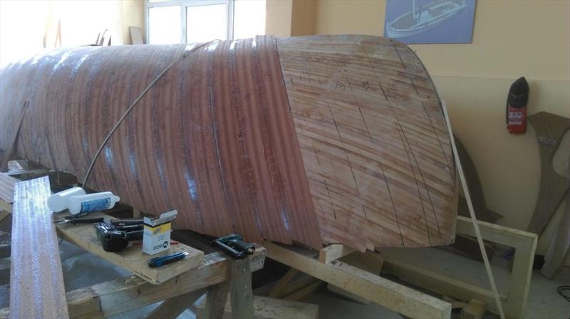 Croatian Gajeta build - planking advances, with each thin strip of mahogany veneer butting up against the next - photo © West System International