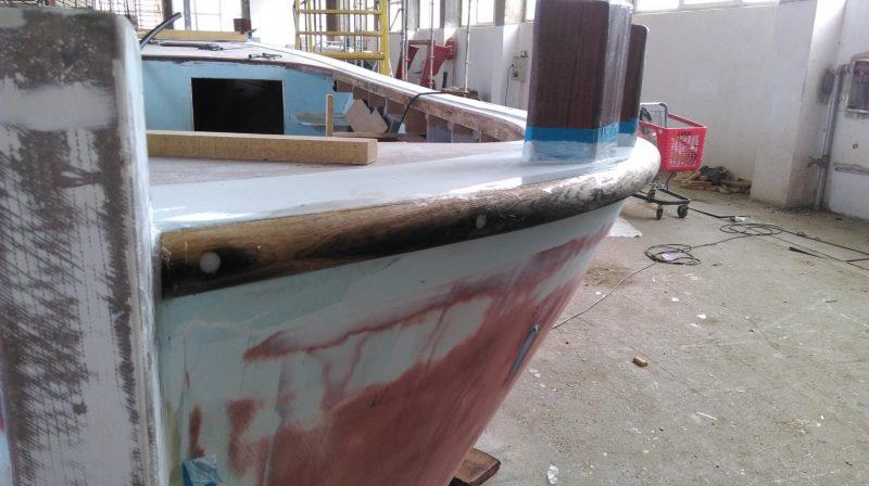 One of the two parallel mahogany rubbing strakes is attached - photo © Wessex Resins & Adhesives